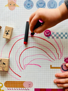 kid drawing on modern and colorful desk pad