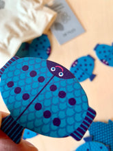 Laden Sie das Bild in den Galerie-Viewer, detail of fish shaped domino matching game with cotton bag