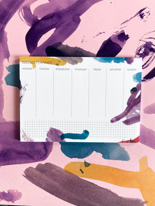 colorful weekly planner with brush pen pattern with abstract pattern gift wrap at the background