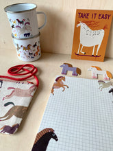 Load image into Gallery viewer, selection of Horse related paper godds from jungwiealt showing matching game, postcard, enamel mug, notepad and unique cotton bag